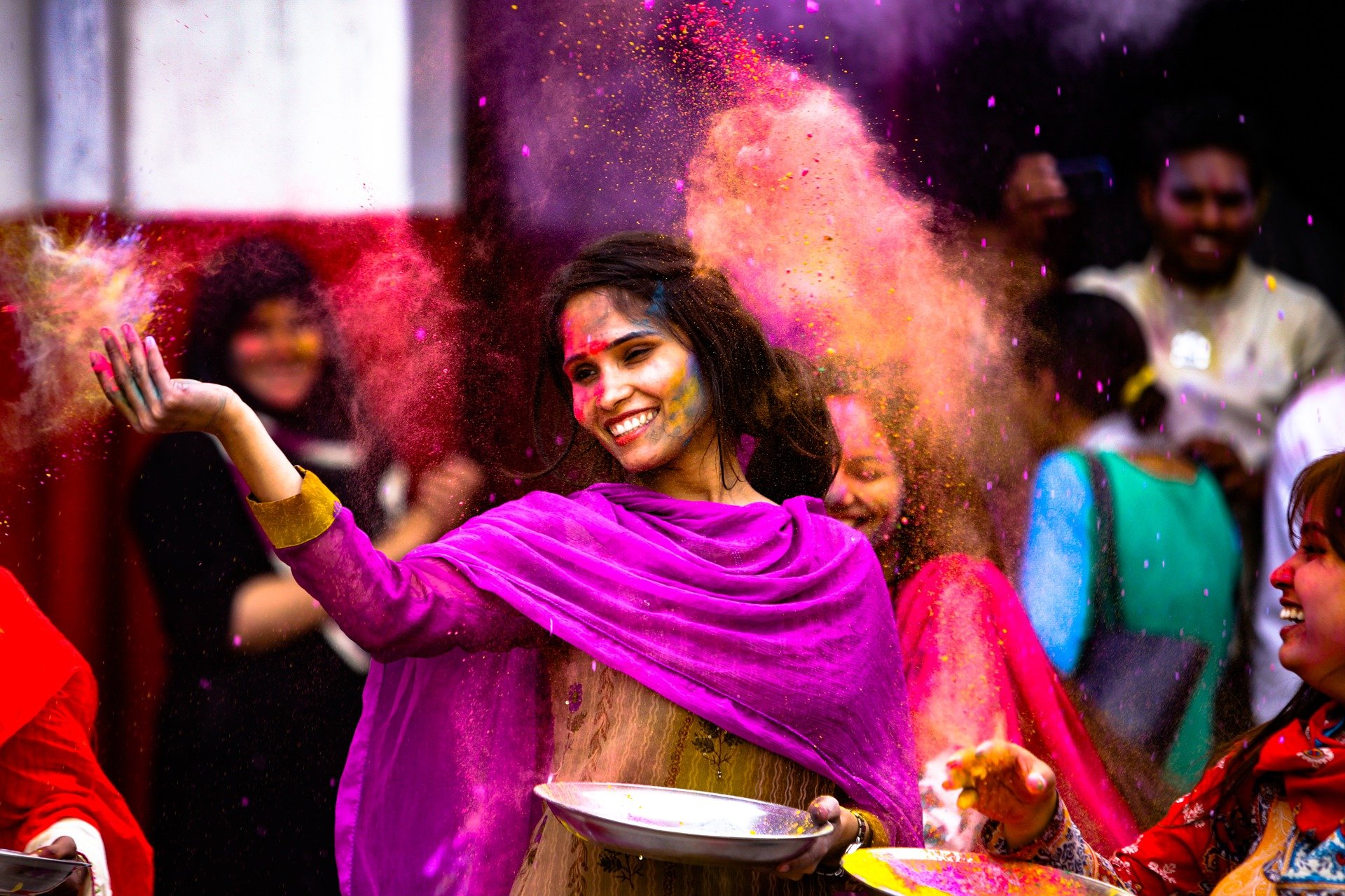 People playing Holi and spreading gulal power in the air