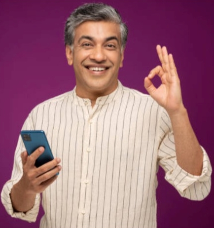 Indian man wearing cream kurta making 'ok' sign with finger and thumb