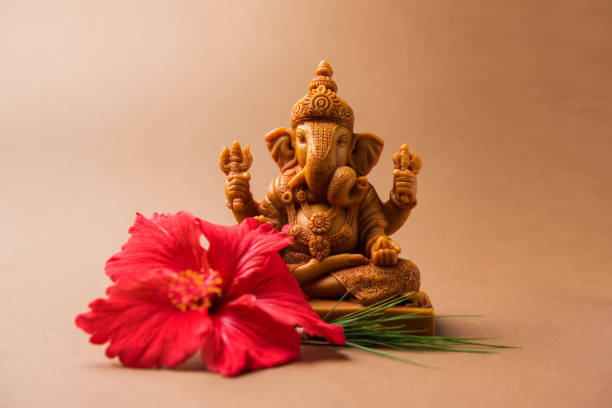 A mutri of Ganesh ji with a flower offering in front
